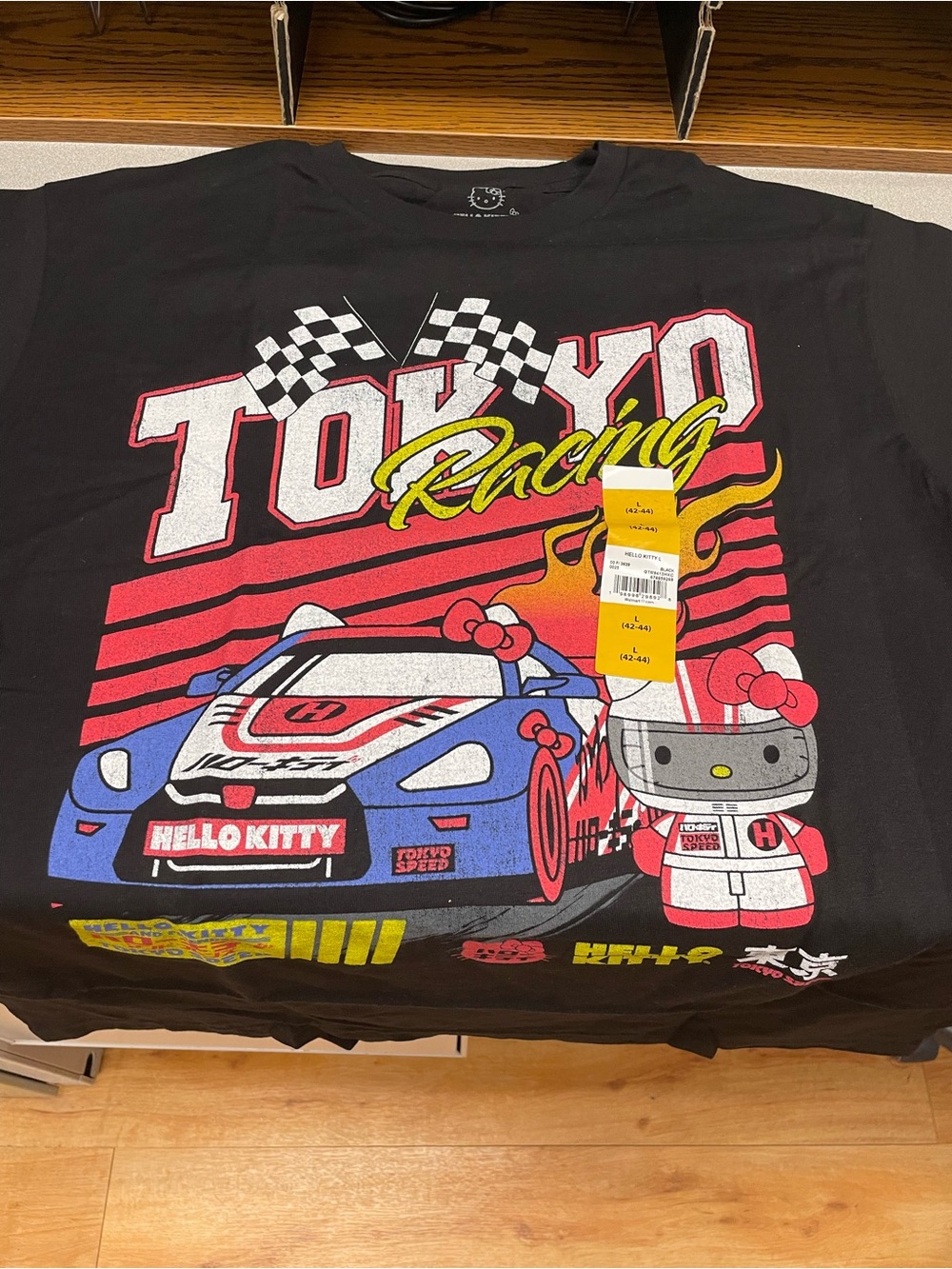 Brand new Hello Kitty Black Racing Graphic Tee top with Red, Yellow & Blue sz L